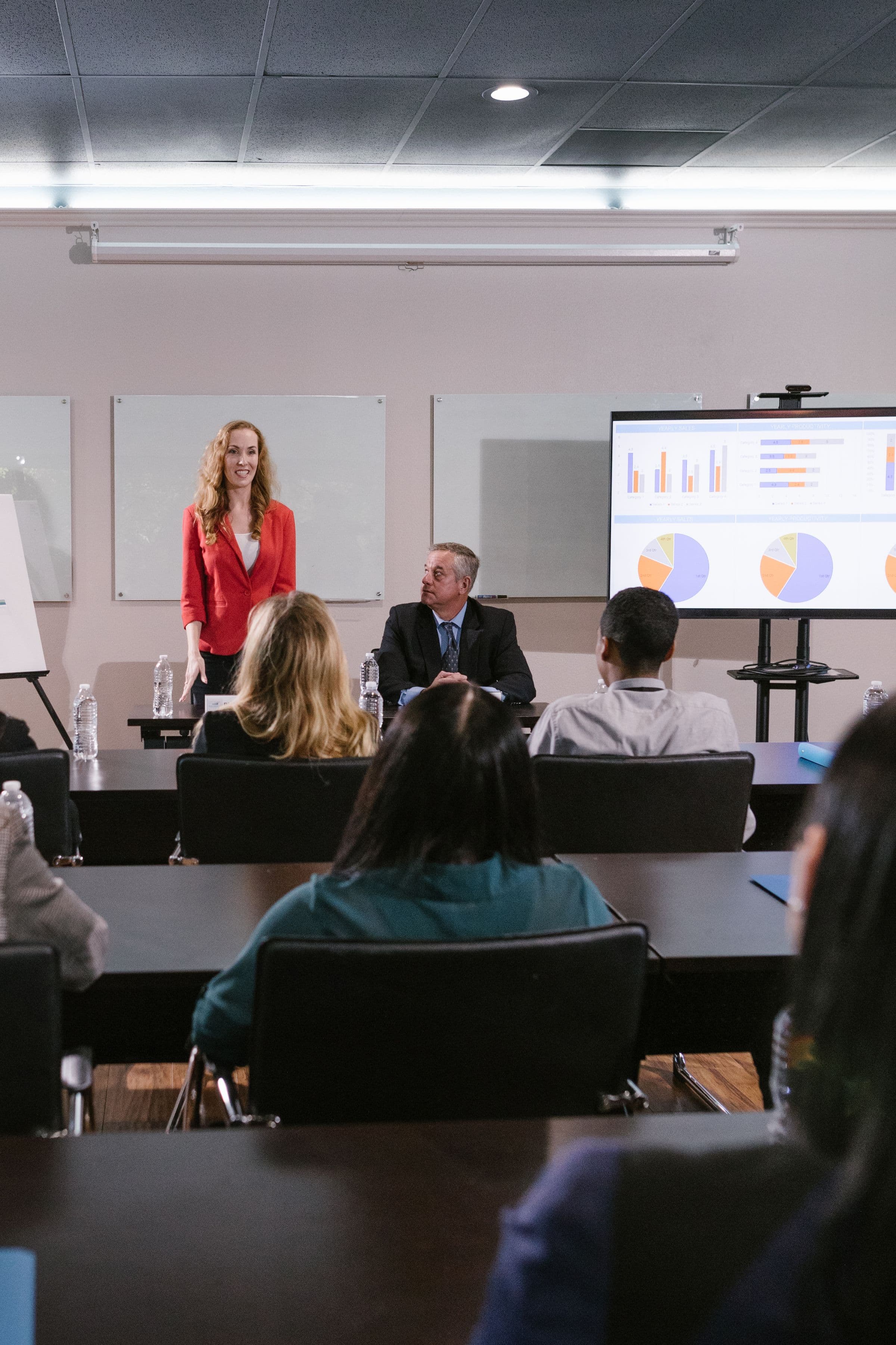 A team presenting data to colleagues during an internal strategy meeting